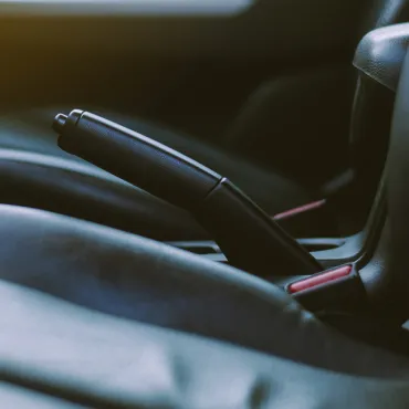 Traditional parking brakes with large hand levers are mechanical systems